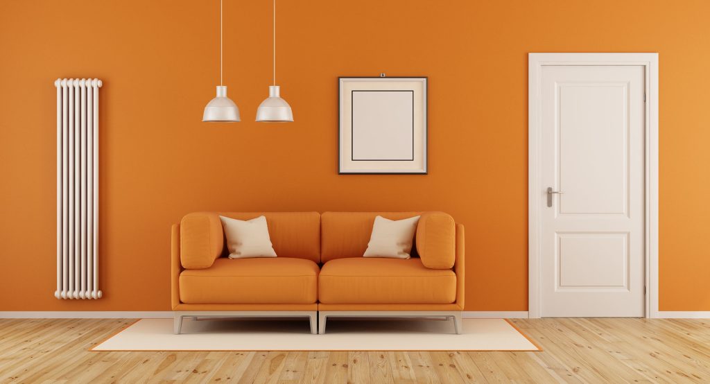 Replacement radiator installed in an orange room